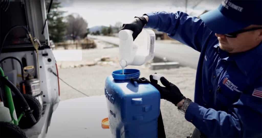 Patriot Pest & Termite Control worker mixes eco-friendly chemicals for extermination