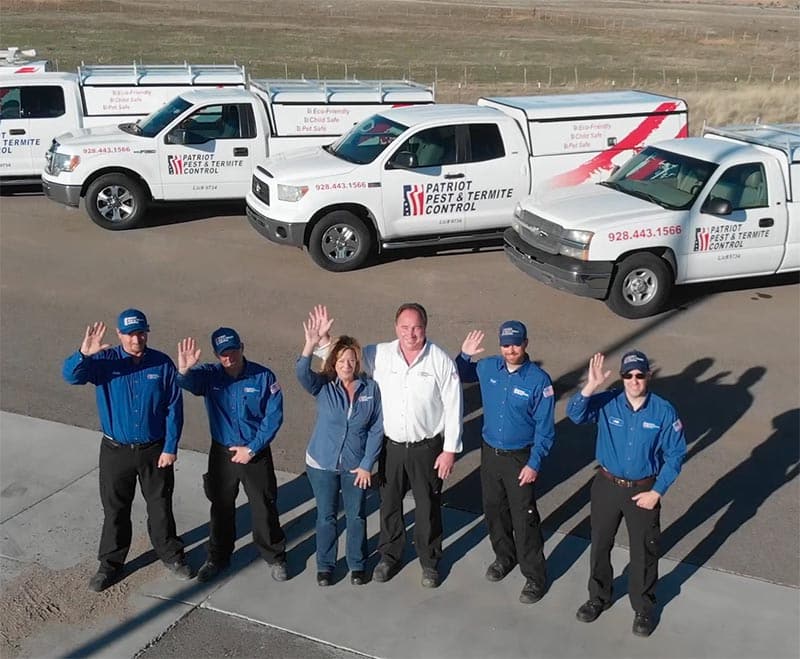 Patriot Pest & Termite Control team waves in front of truck fleet in Arizona