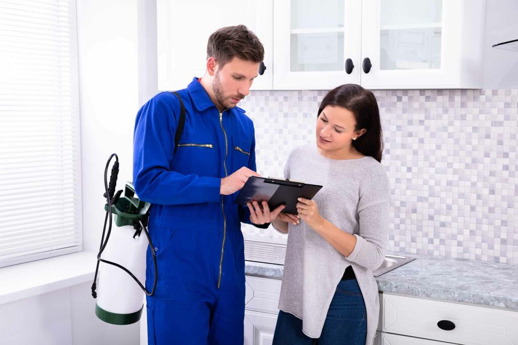 Exterminator going over home inspection with client