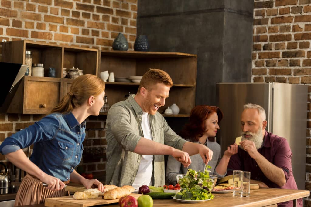 multigeneration family cooking family together in kitchen at home